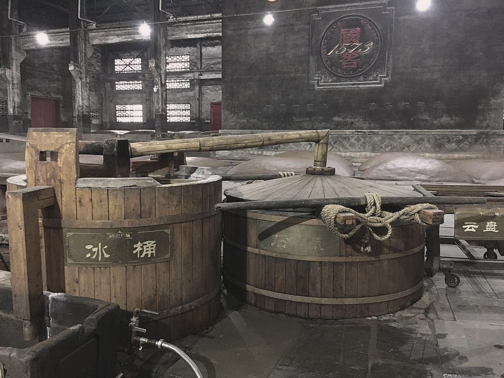 A traditional still in the Luzhou Laojiao distillery. In the back, there are the fermentation pits that have been operating non-stop since 1573. Source: Xiaomage de/Wikimedia A traditional still in the Luzhou Laojiao distillery. In the back, there are the fermentation pits that have been operating non-stop since 1573. Source: Xiaomage de/Wikimedia