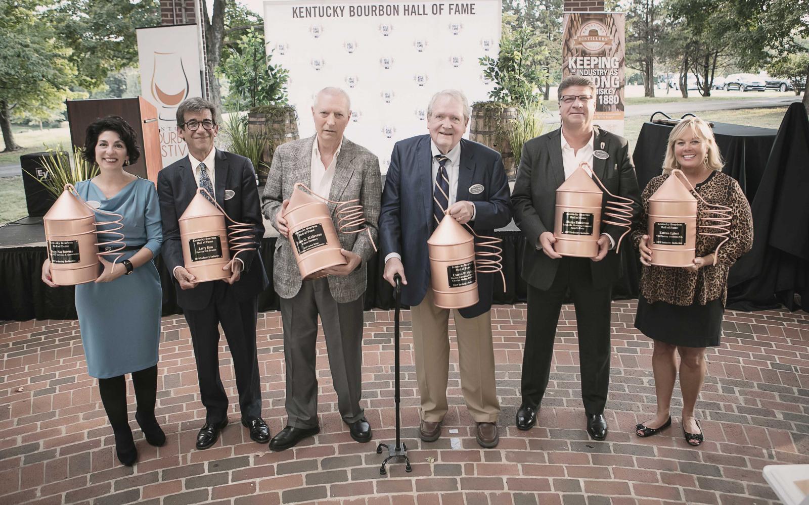 2019 recipients: Peggy Noe Stevens (left), Larry Kass, Even G. Kulsveen, Charles W. Medley, Wesley Henderson, and Katrina Egbert. Photo: The Bourbon Hall of Fame 2019 recipients: Peggy Noe Stevens (left), Larry Kass, Even G. Kulsveen, Charles W. Medley, Wesley Henderson, and Katrina Egbert. Photo: The Bourbon Hall of Fame